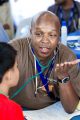 Anesthesiologist Charles Kabetu talking with child